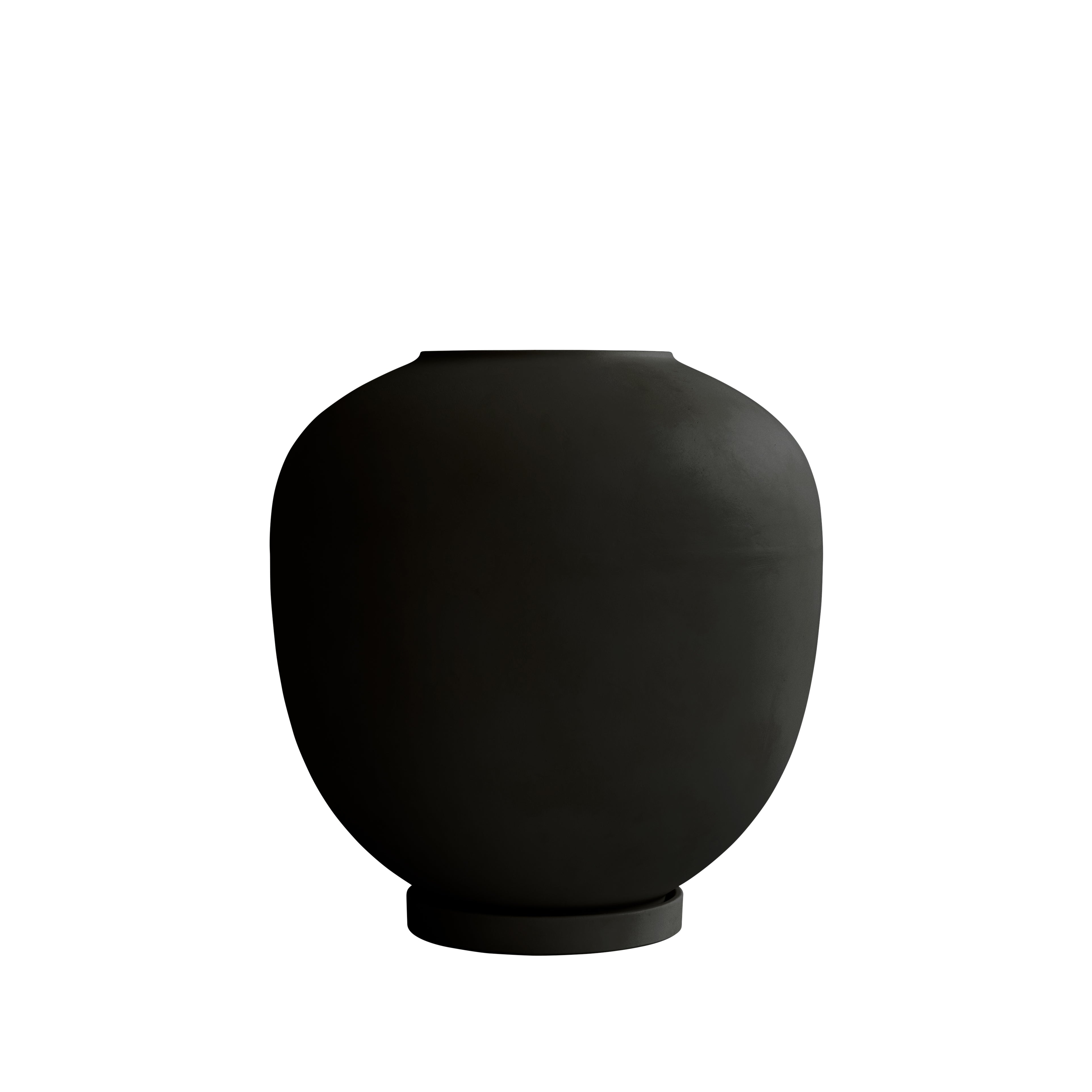 A large black Sunao Vase with a matte finish, photographed against a white background. The vase features a wide, curved body and a narrow opening.